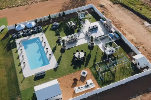 The expansive backyard transforms with ease—perfect for poolside lounging by day and unforgettable wedding celebrations by